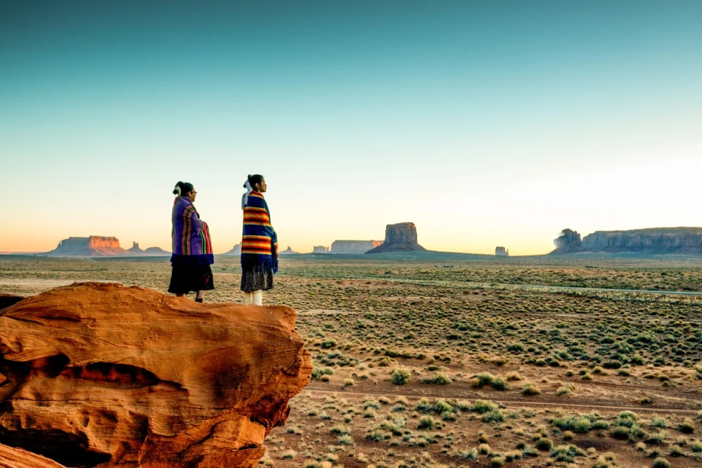 two american indians looking at a cultural land canyon