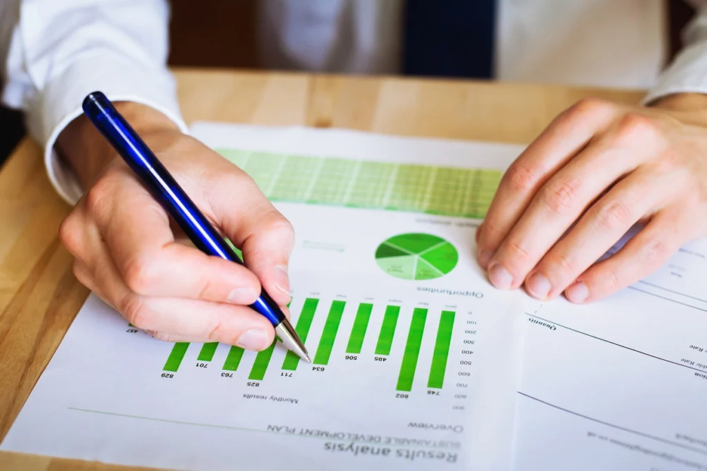 man pointing using a pen to point at graphs in an environmental condition report