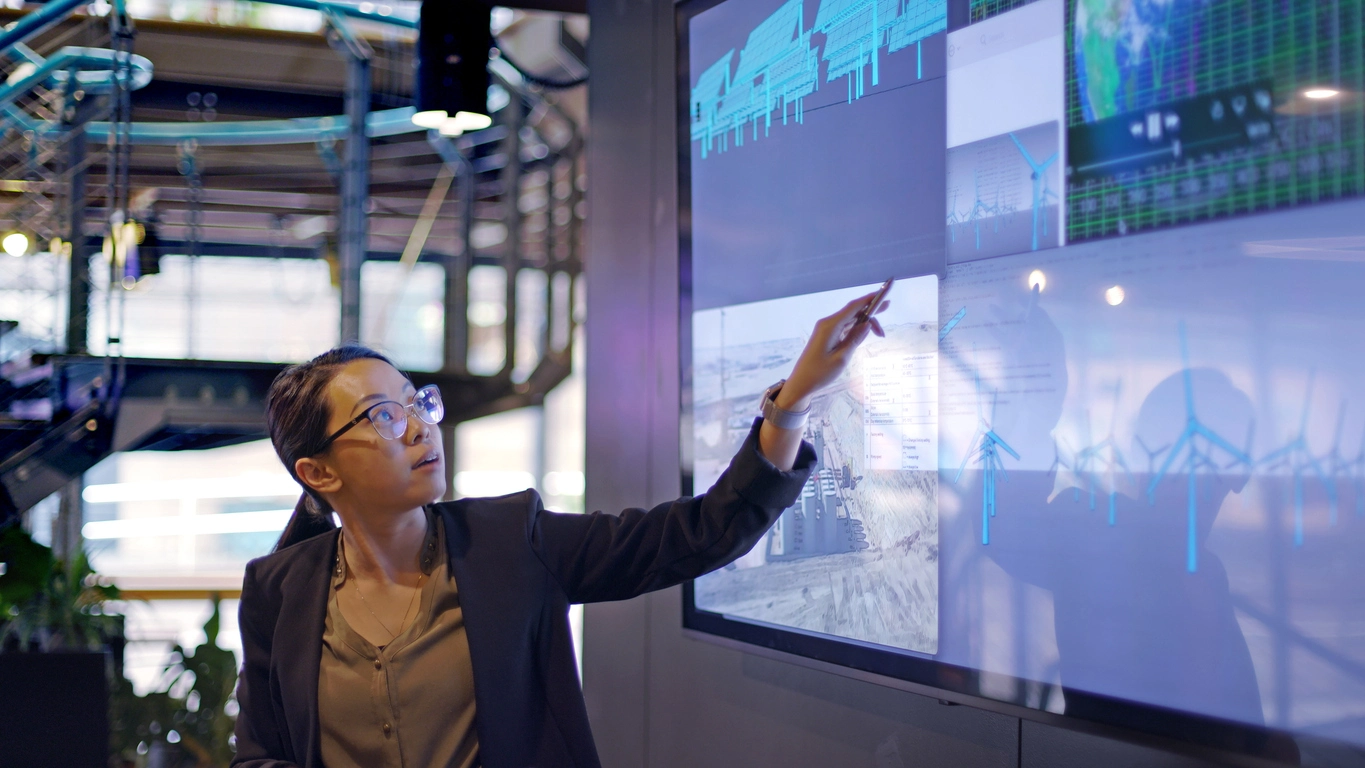 a woman pointing at a screen with ASTM Transaction Screen elements